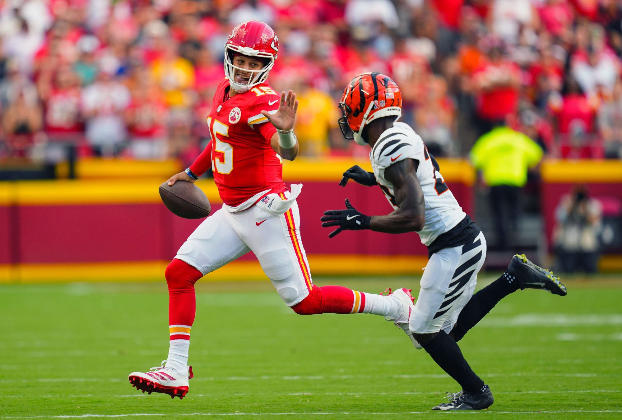 Sep 15, 2024; Kansas City, Missouri, USA; Kansas City Chiefs quarterback Patrick Mahomes (15) runs the ball against Cincinnati Bengals cornerback Dax Hill (23) during the first half at GEHA Field at Arrowhead Stadium.