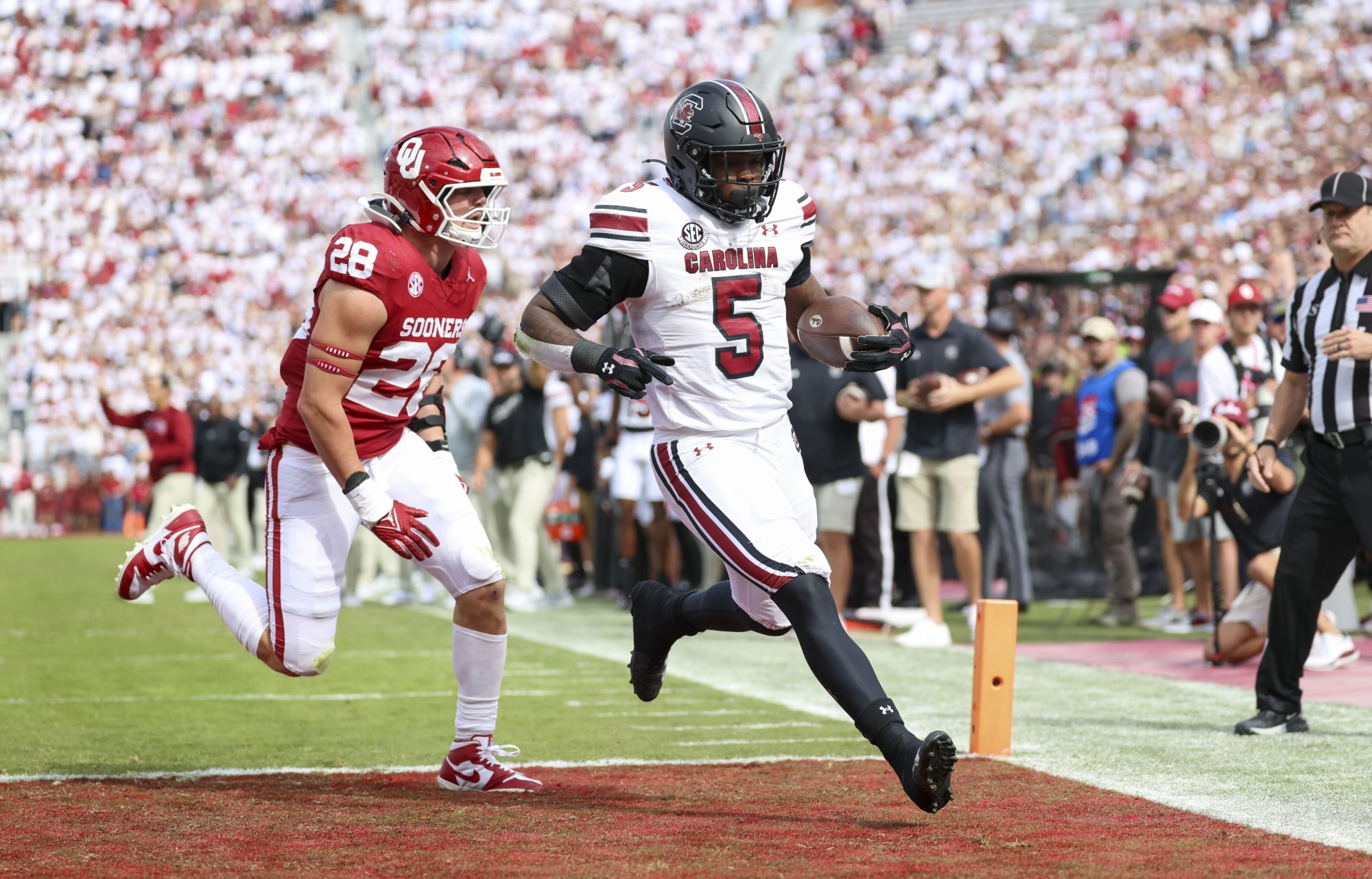 Oct 19, 2024; Norman, Oklahoma, USA; South Carolina Gamecocks running back Raheim Sanders (5) scores a touchdown past Oklahoma Sooners linebacker Danny Stutsman (28) during the first half at Gaylord Family-Oklahoma Memorial Stadium.