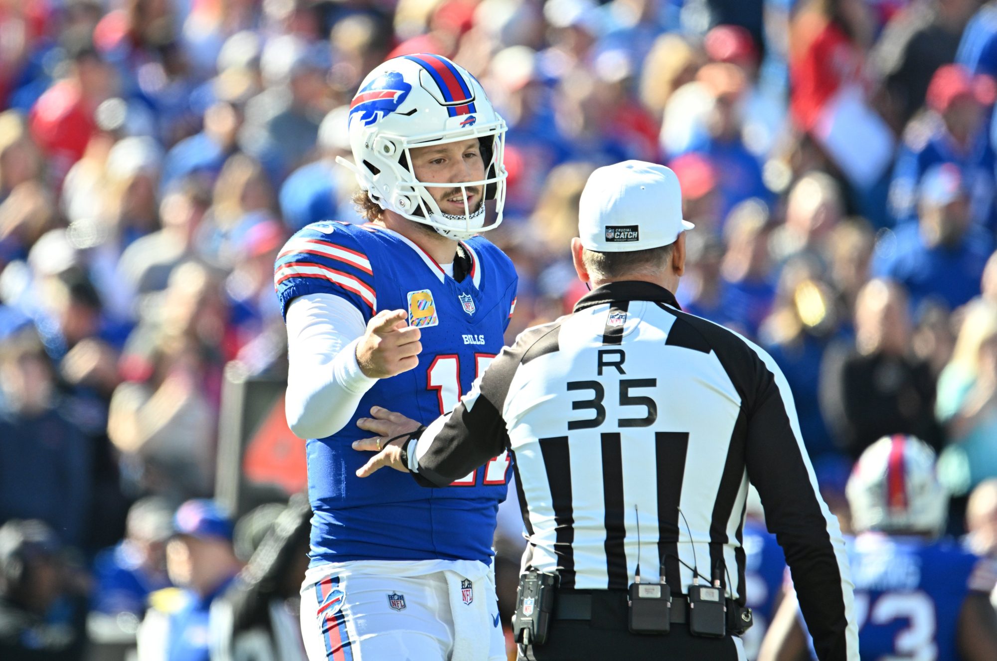 Oct 20, 2024; Orchard Park, New York, USA; Buffalo Bills quarterback Josh Allen (17) talks with referee John Hussey (35) in the first quarter at Highmark Stadium.