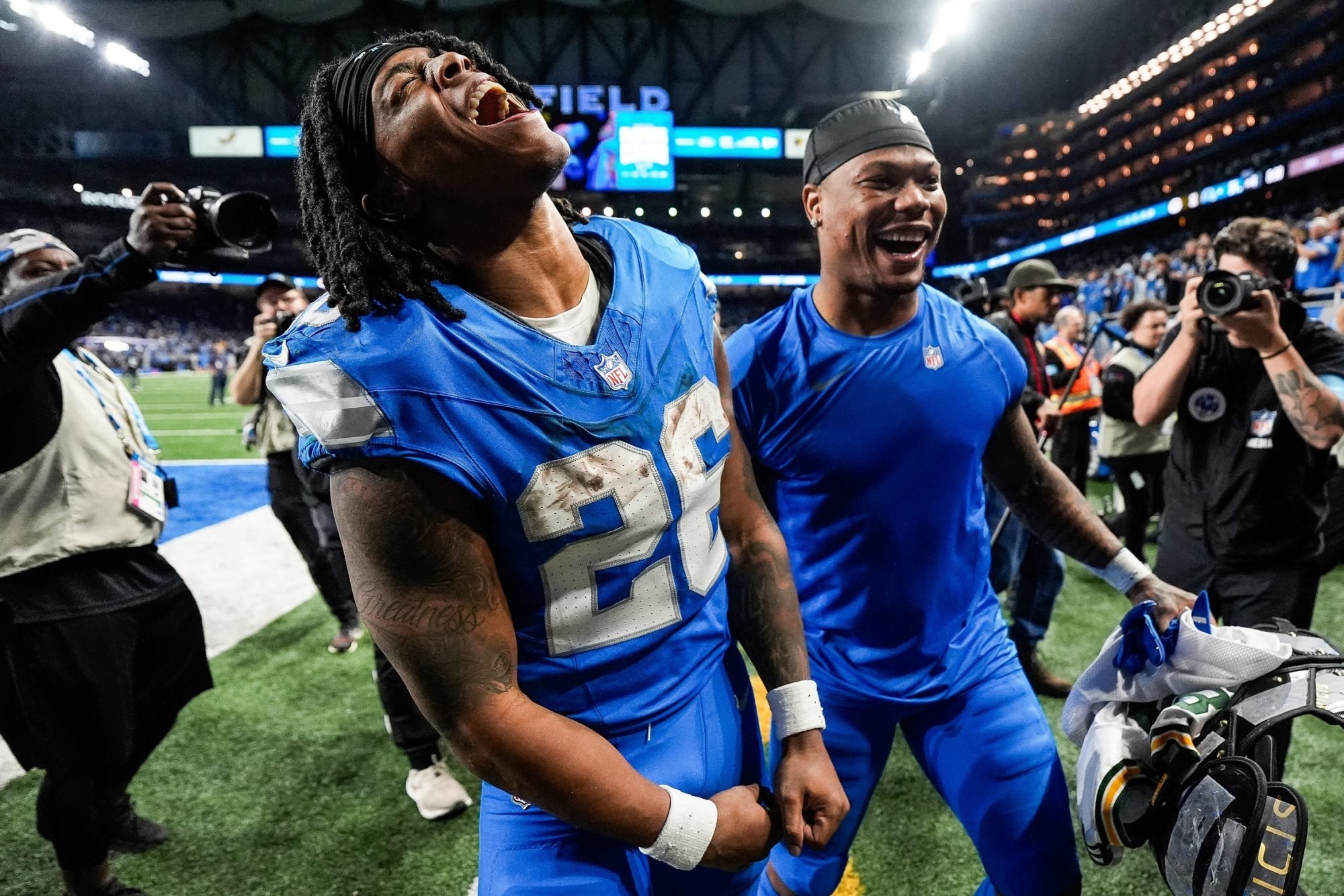 Detroit Lions running back Jahmyr Gibbs (26) and running back David Montgomery (5) celebrate 34-31 win over Green Bay Packers as he exits the field at Ford Field in Detroit on Thursday, Dec. 5, 2024.