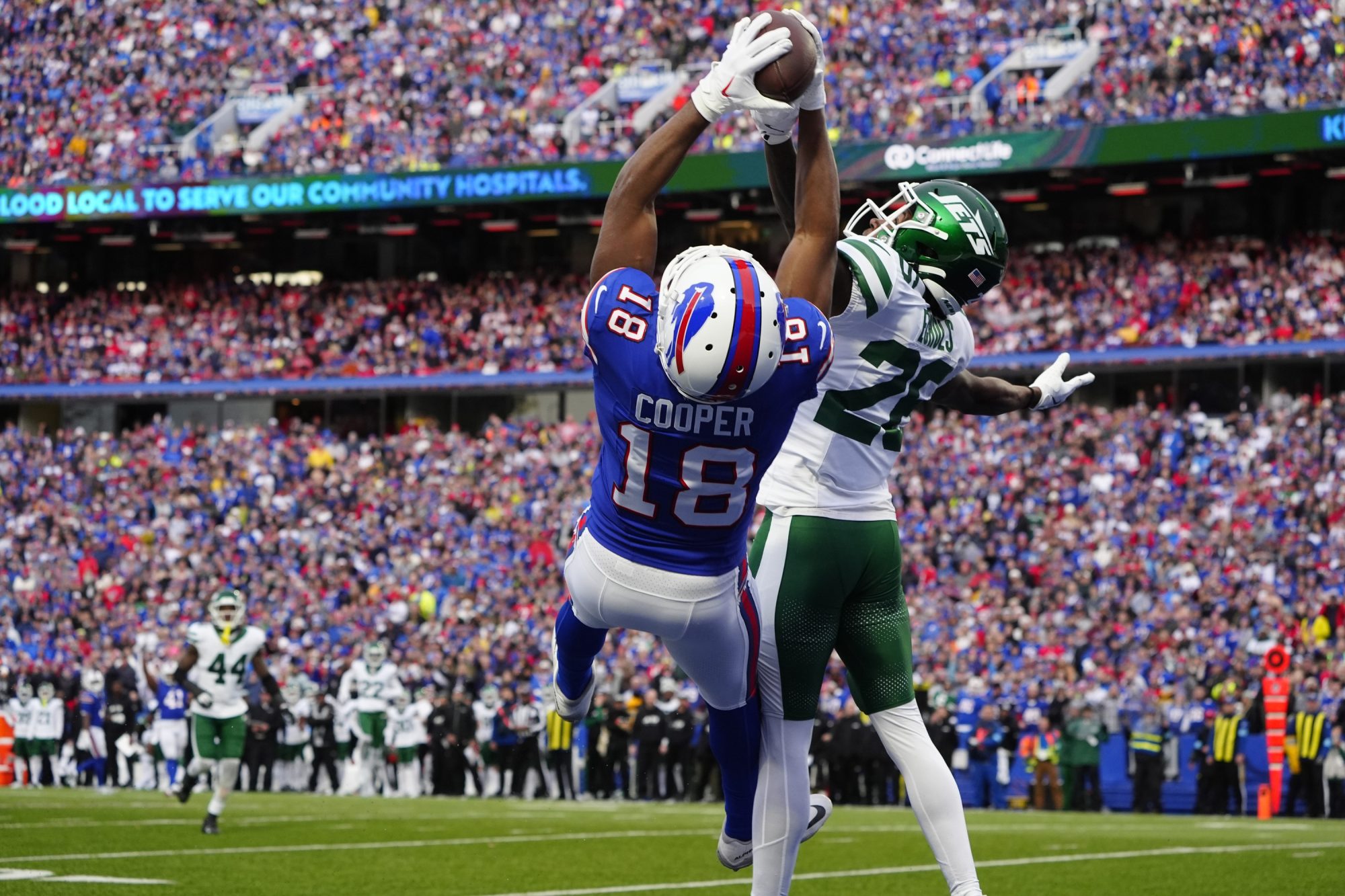 Dec 29, 2024; Orchard Park, New York, USA; Buffalo Bills wide receiver Amari Cooper (18) makes a catch for a touchdown against New York Jets cornerback Brandin Echols (26) during the second half at Highmark Stadium.