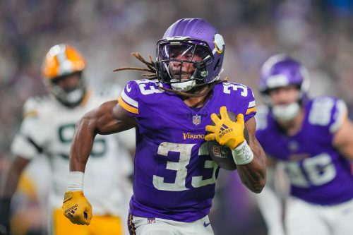 Dec 29, 2024; Minneapolis, Minnesota, USA; Minnesota Vikings running back Aaron Jones (33) runs with the ball against Green Bay Packers in the third quarter at U.S. Bank Stadium.