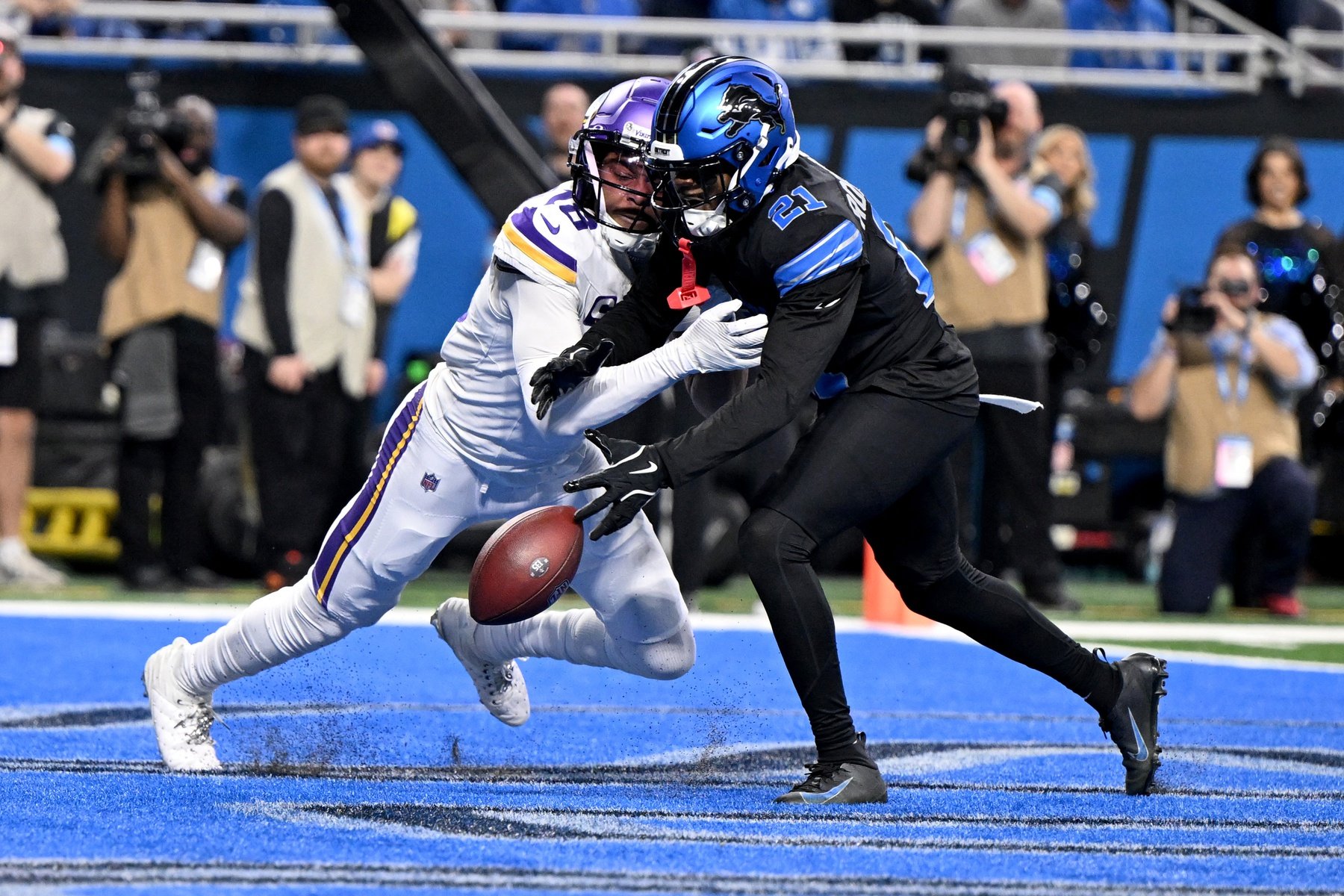 Jan 5, 2025; Detroit, Michigan, USA; Detroit Lions cornerback Amik Robertson (21) breaks up a pass in the end zone intended for Minnesota Vikings wide receiver Justin Jefferson (18) in the second quarter at Ford Field.