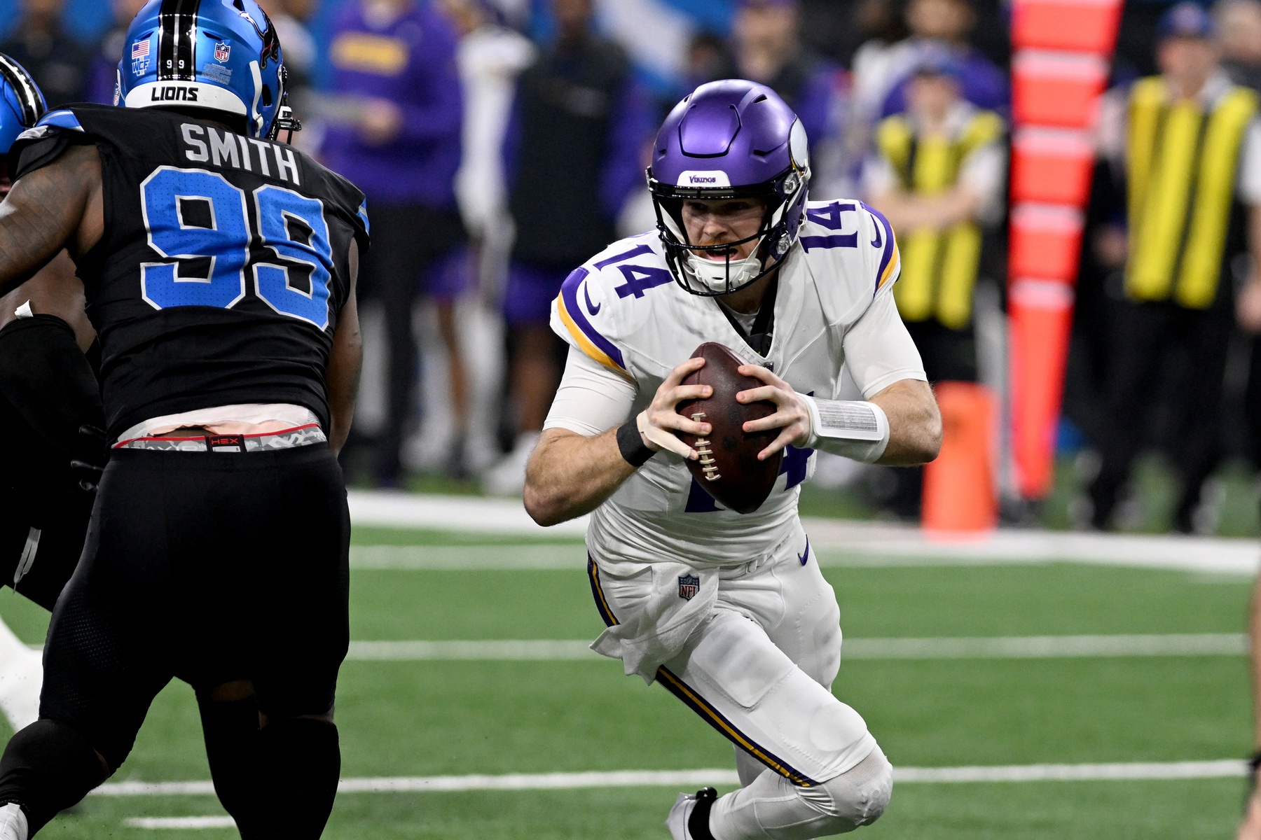 Jan 5, 2025; Detroit, Michigan, USA; A Minnesota Vikings quarterback Sam Darnold (14) scrambles out of the pocket against the Detroit Lions in the second quarter at Ford Field.