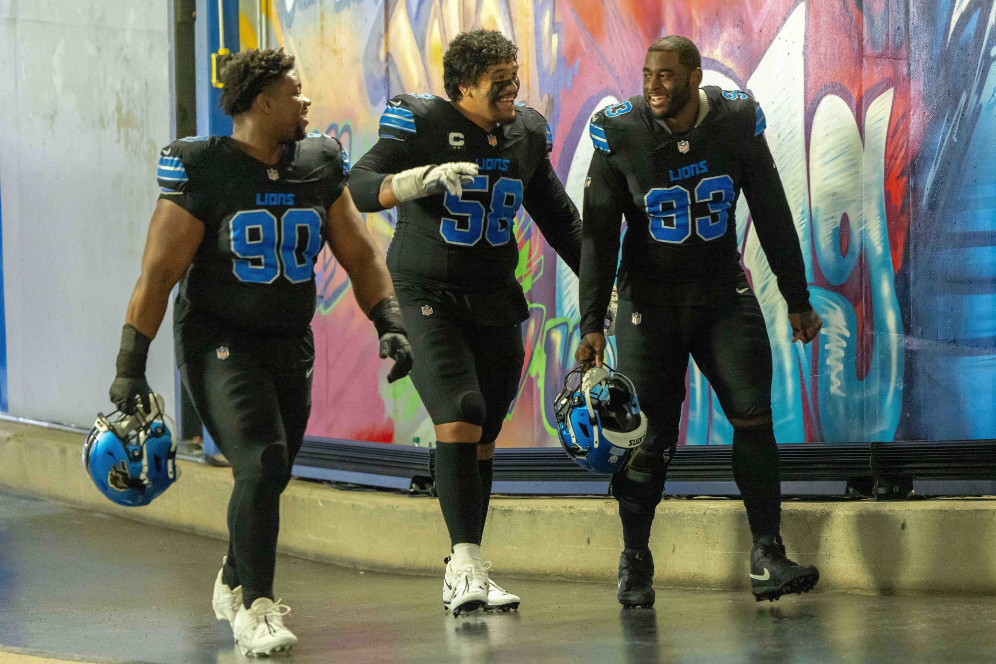 Jan 5, 2025; Detroit, Michigan, USA; Detroit Lions defensive tackle Chris Smith (90), offensive tackle Penei Sewell (58) and defensive end Josh Paschal (93) walk up the tunnel after the game against the Minnesota Vikings at Ford Field.