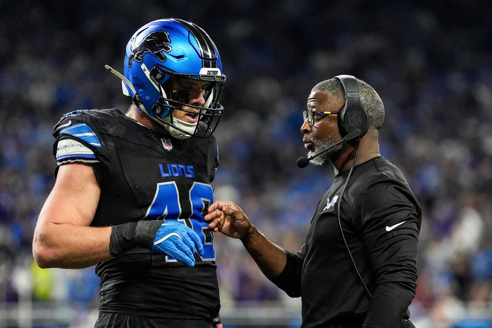 Detroit Lions defensive coordinator Aaron Glenn talks with linebacker Jack Campbell during the first half against the Minnesota Vikings at Ford Field in Detroit on Sunday, Jan. 5, 2025.