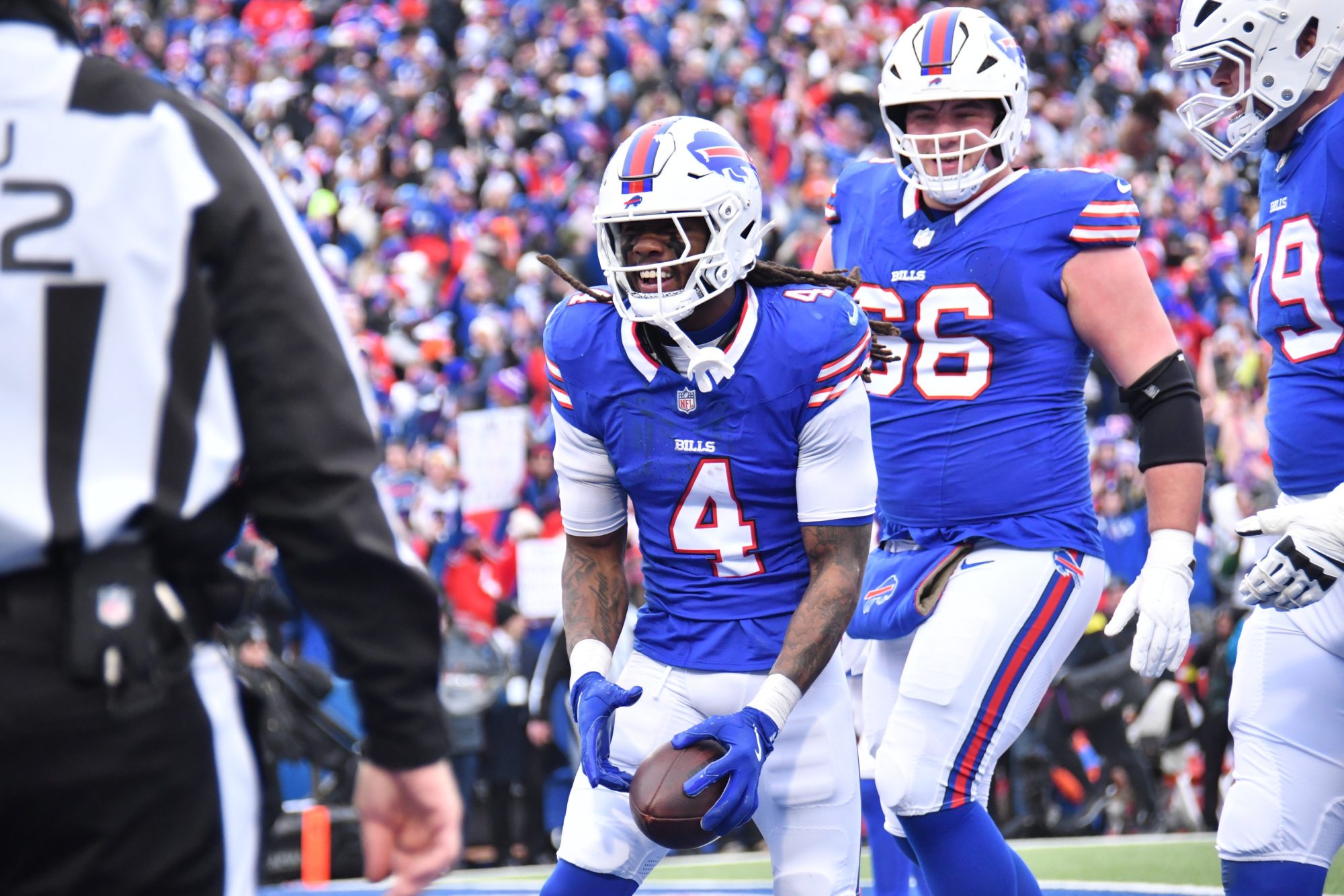 Jan 12, 2025; Orchard Park, New York, USA; Buffalo Bills running back James Cook (4) celebrates a touchdown during the second quarter against the Denver Broncos in an AFC wild card game at Highmark Stadium.