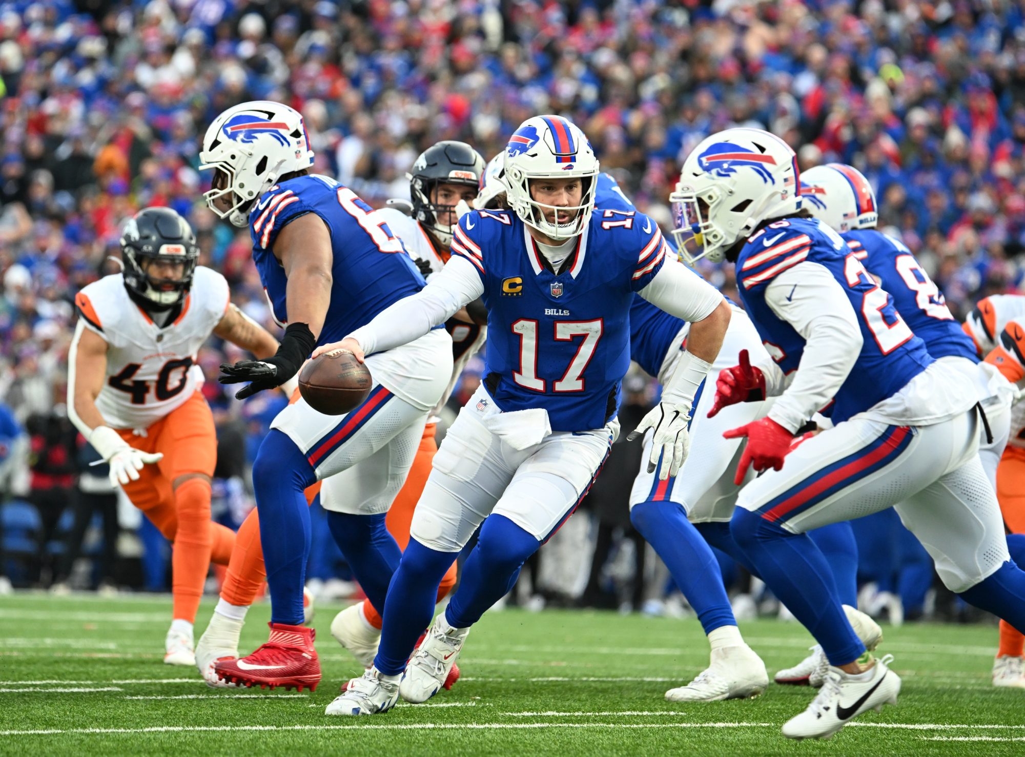 Jan 12, 2025; Orchard Park, New York, USA; Buffalo Bills quarterback Josh Allen (17) hands the ball off to running back Ty Johnson (26) during the fourth quarter against the Denver Broncos in an AFC wild card game at Highmark Stadium.