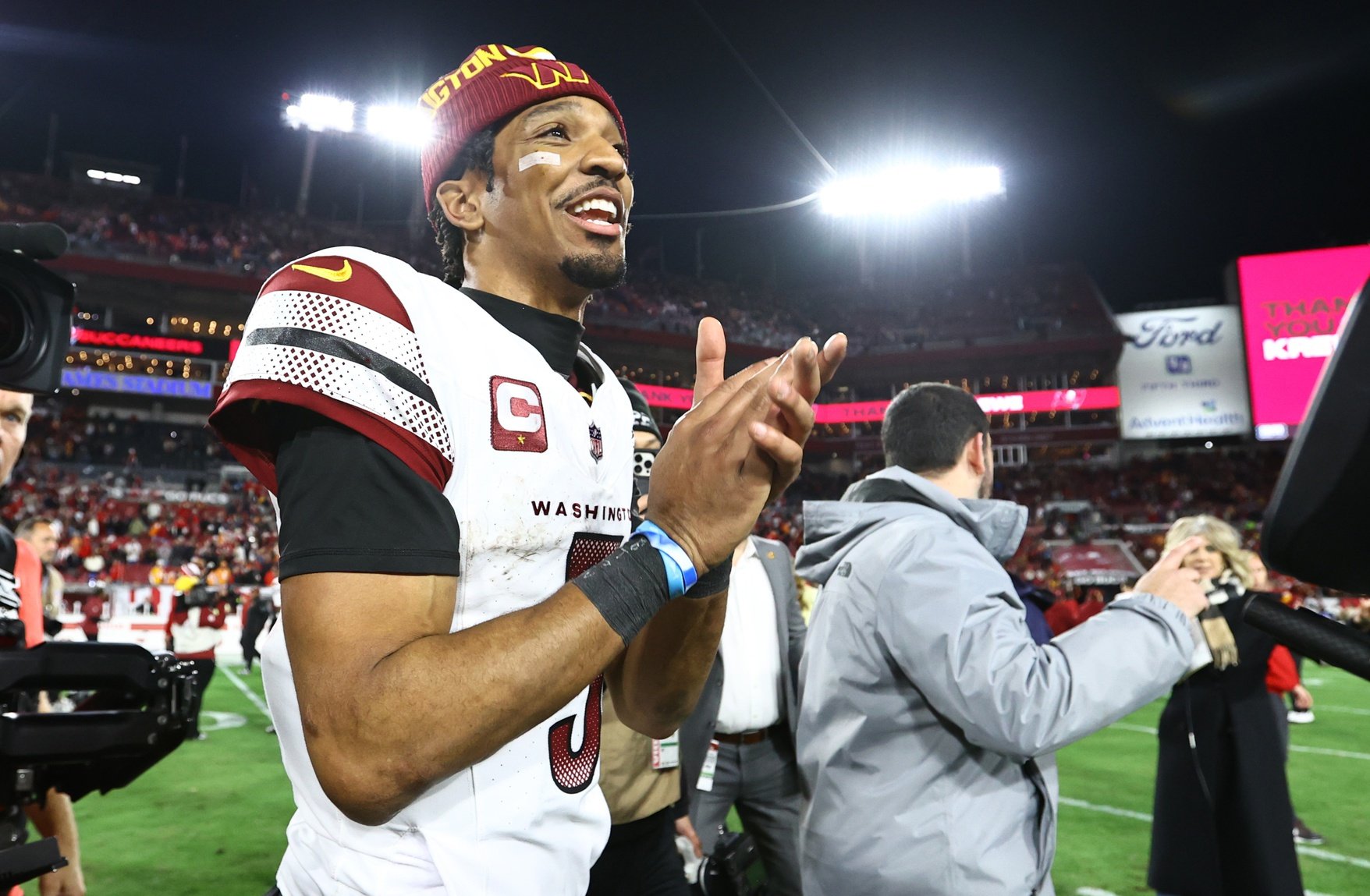 Jan 12, 2025; Tampa, Florida, USA; Washington Commanders quarterback Jayden Daniels (5) celebrates after winning a NFC wild card playoff against the Tampa Bay Buccaneers at Raymond James Stadium.