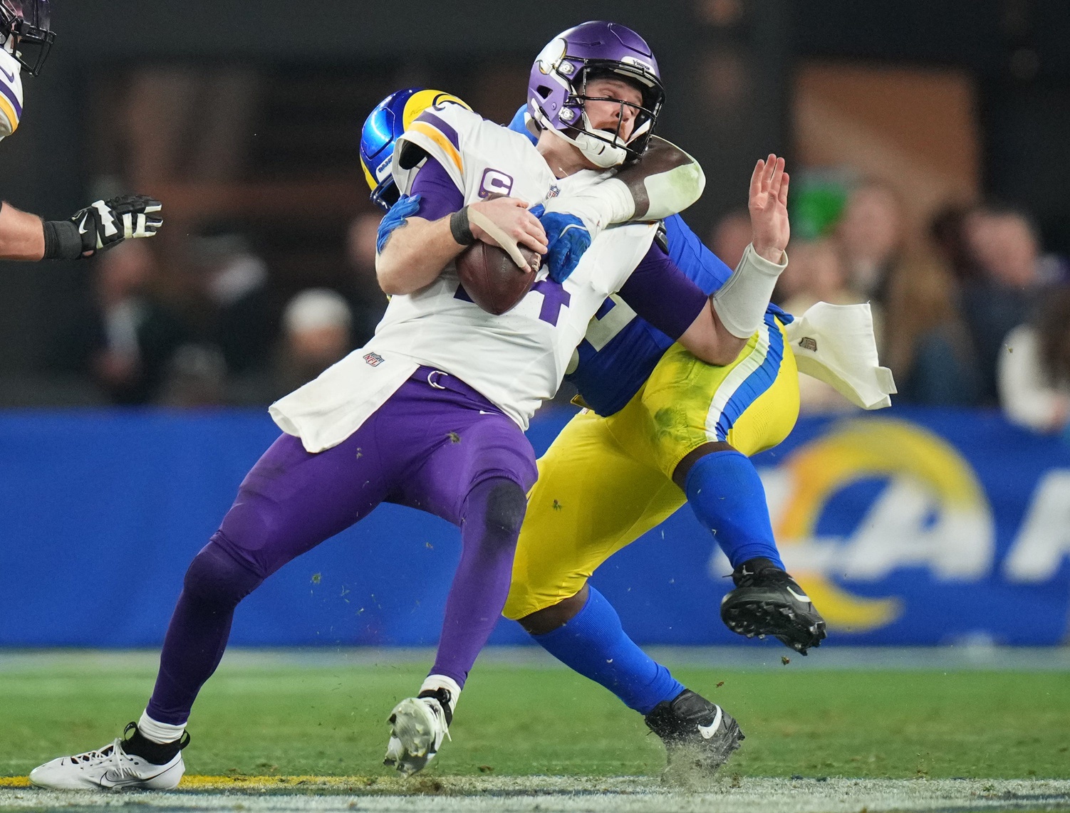 Los Angeles Rams defensive lineman Neville Gallimore (92) sacks Minnesota Vikings quarterback Sam Darnold (14) during their playoff game at State Farm Stadium on Jan. 13, 2025, in Glendale. The Rams beat the Vikings, 27-9.