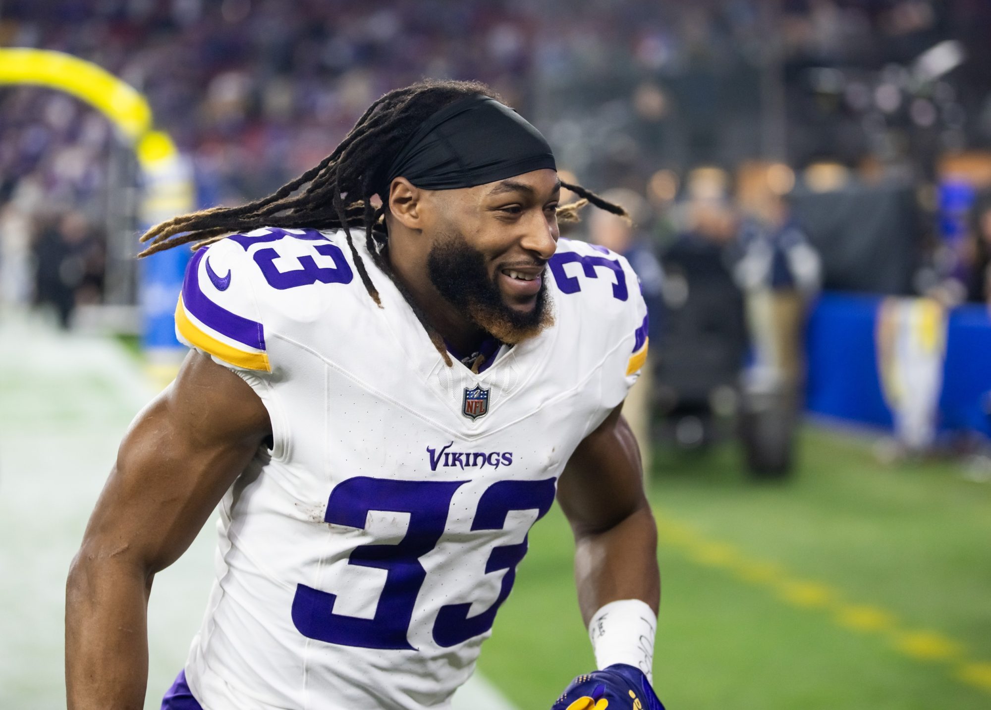 Jan 13, 2025; Glendale, AZ, USA; Minnesota Vikings running back Aaron Jones Sr. (33) against the Los Angeles Rams during an NFC wild card game at State Farm Stadium.