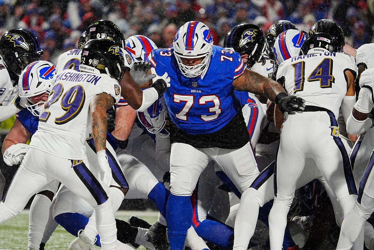 Buffalo Bills Dion Dawkins blocks for quarterback Josh Allen, behind him, who sneaks in for a touchdown during first half action at the Buffalo Bills divisional game against the Baltimore Ravens at Highmark Stadium in Orchard Park on Jan. 19, 2025.