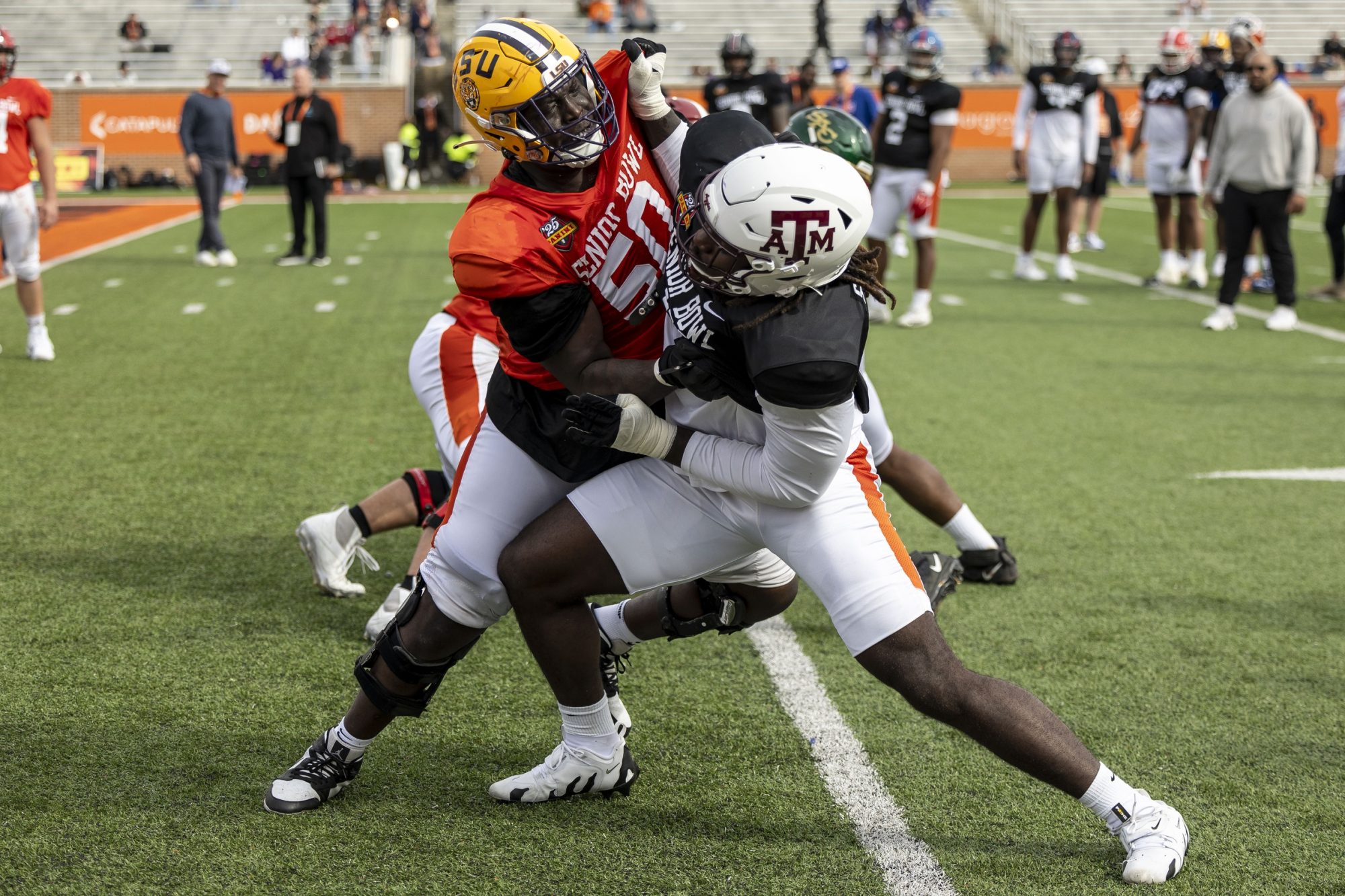 Jan 28, 2025; Mobile, AL, USA; American team offensive lineman Emery Jones of LSU (50) spars with American team defensive lineman Shemar Stewart of Texas A&M (14) during Senior Bowl practice for the American team at Hancock Whitney Stadium.