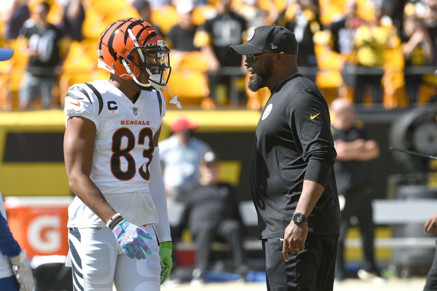 Sep 19, 2021; Pittsburgh, Pennsylvania, USA; Cincinnati Bengals wide receiver Tyler Boyd (left) meets with Pittsburgh Steelers head coach Mike Tomlin before their game at Heinz Field.