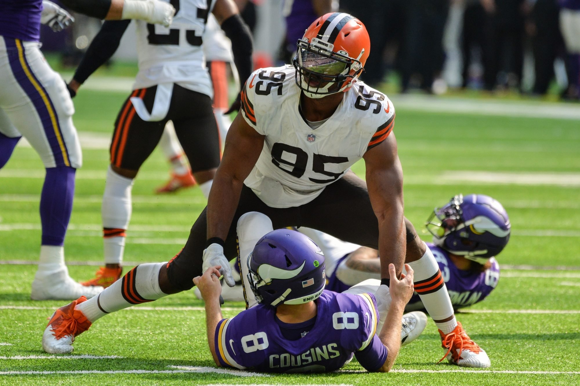 Oct 3, 2021; Minneapolis, Minnesota, USA; Cleveland Browns defensive end Myles Garrett (95) wraps up Minnesota Vikings quarterback Kirk Cousins (8) during the third quarter at U.S. Bank Stadium.