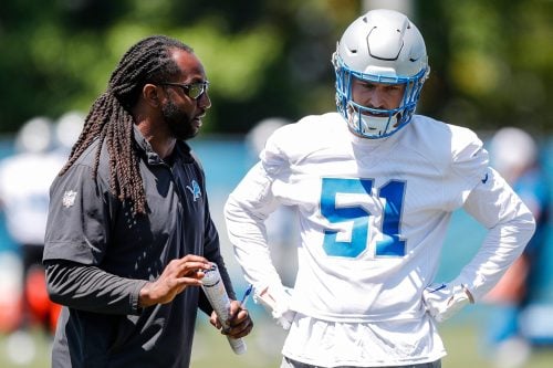 Detroit Lions linebackers coach Kelvin Sheppard talks to linebacker Ben Niemann (51) during OTAs at Detroit Lions headquarters and practice facility in Allen Park on Tuesday, June 11, 2024.