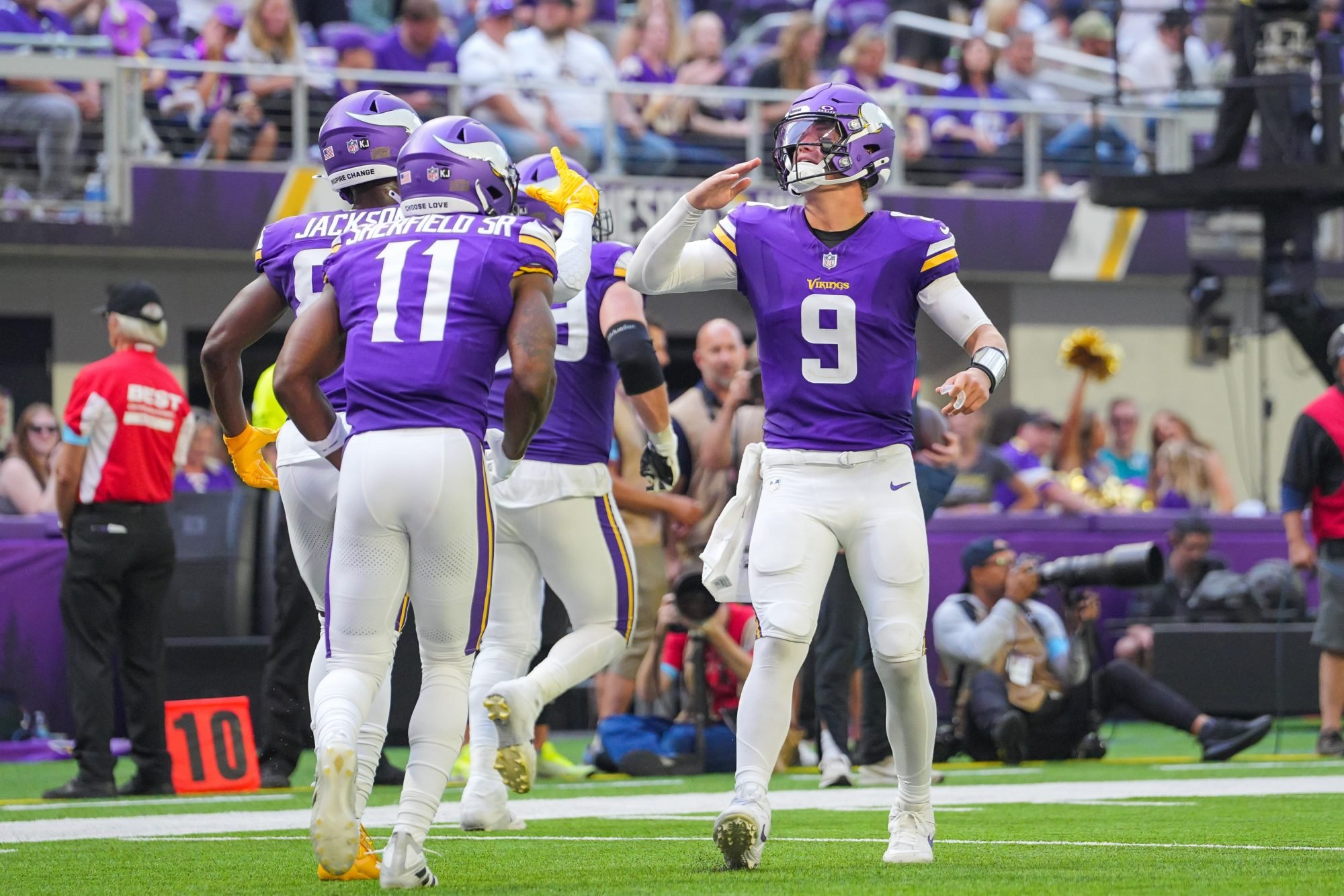 Aug 10, 2024; Minneapolis, Minnesota, USA; Minnesota Vikings quarterback J.J. McCarthy (9) celebrates wide receiver Trent Sherfield Sr. (11) touchdown against the Las Vegas Raiders in the third quarter at U.S. Bank Stadium.