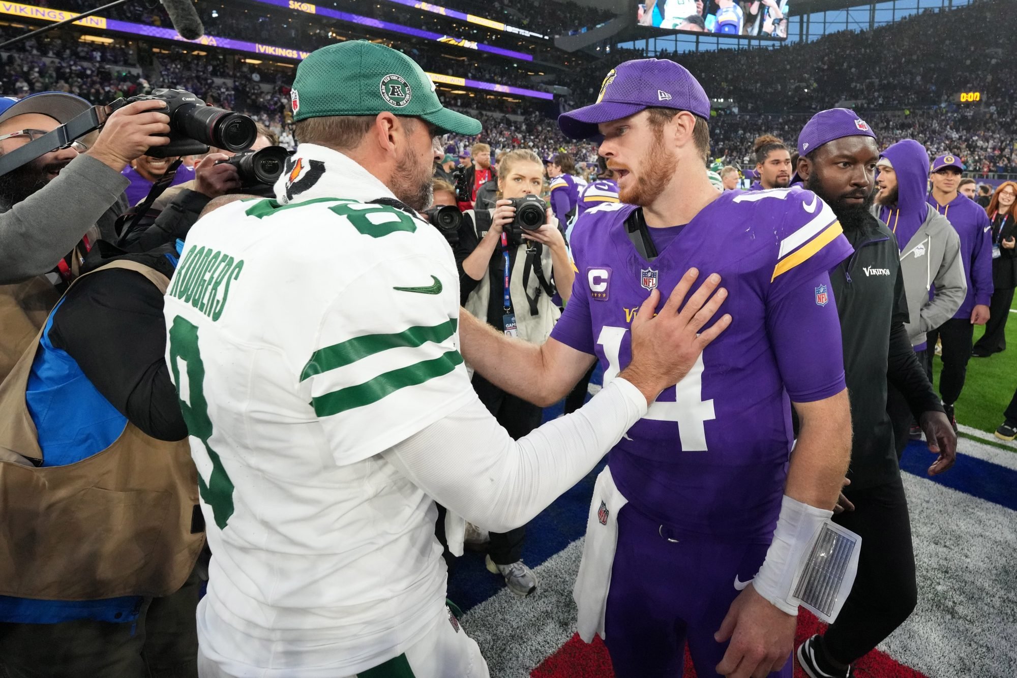 Oct 6, 2024; London, United Kingdom; New York Jets quarterback Aaron Rodgers (8) shakes hands with Minnesota Vikings quarterback Sam Darnold (14) after the game at Tottenham Hotspur Stadium.