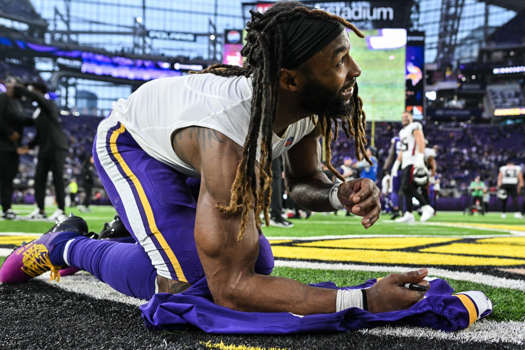 Dec 8, 2024; Minneapolis, Minnesota, USA; Minnesota Vikings running back Aaron Jones (33) signs his jersey after the game against the Atlanta Falcons at U.S. Bank Stadium.