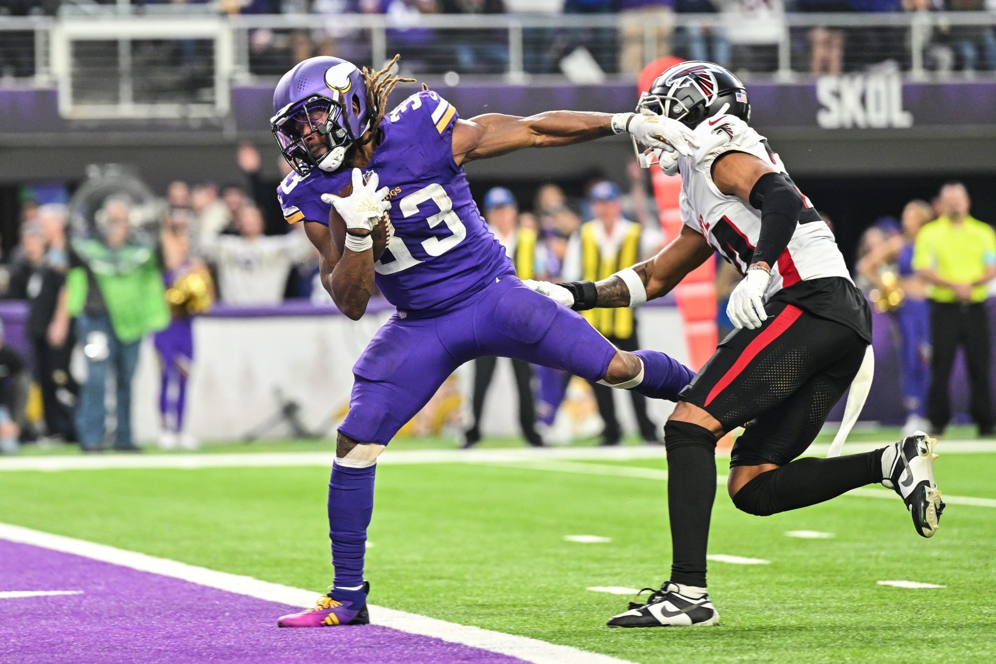 Dec 8, 2024; Minneapolis, Minnesota, USA; Minnesota Vikings running back Aaron Jones (33) runs for a touchdown as Atlanta Falcons cornerback A.J. Terrell (24) attempts to make the tackle during the fourth quarter at U.S. Bank Stadium.