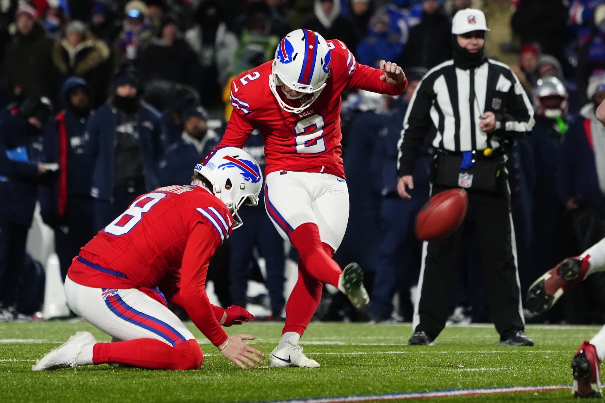 Dec 22, 2024; Orchard Park, New York, USA; Buffalo Bills place kicker Tyler Bass (2) kicks an extra point against the New England Patriots during the second half at Highmark Stadium.