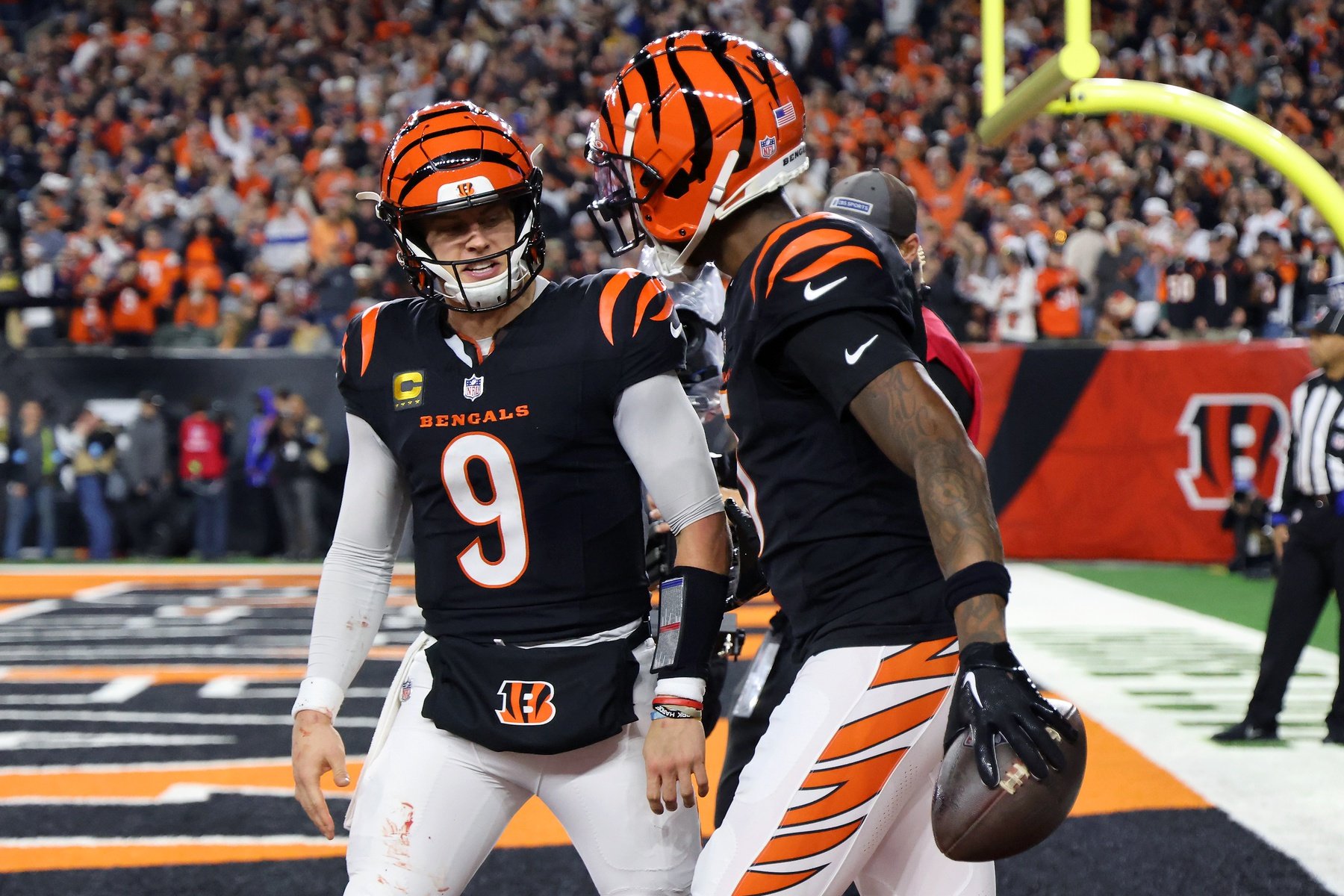 Dec 28, 2024; Cincinnati, Ohio, USA; Cincinnati Bengals quarterback Joe Burrow (9) celebrates following his touchdown pass to wide receiver Tee Higgins (5) during the fourth quarter against the Denver Broncos at Paycor Stadium.