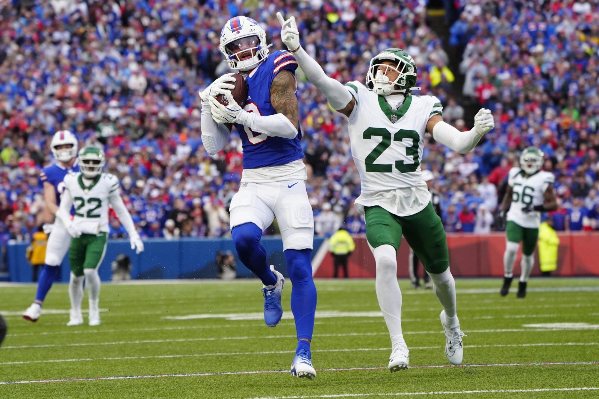 Dec 29, 2024; Orchard Park, New York, USA; Buffalo Bills wide receiver Keon Coleman (0) makes a catch against New York Jets cornerback Isaiah Oliver (23) during the first half at Highmark Stadium.