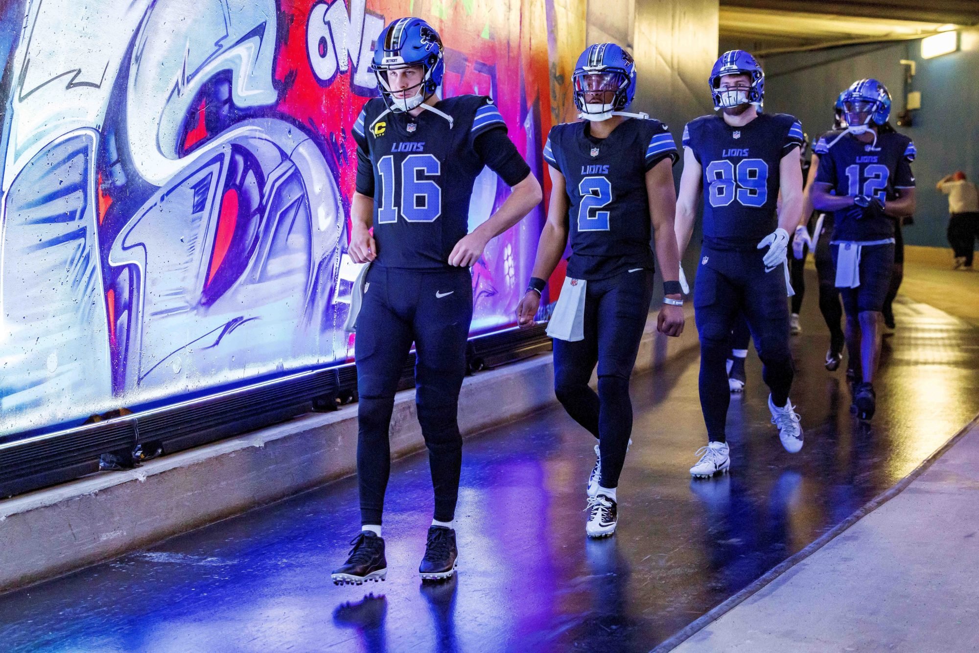 Jan 5, 2025; Detroit, Michigan, USA; Detroit Lions quarterback Jared Goff (16), quarterback Hendon Hooker (2) and running back Craig Reynolds (13) walk out to the field for warm ups before the game against the Minnesota Vikings at Ford Field.