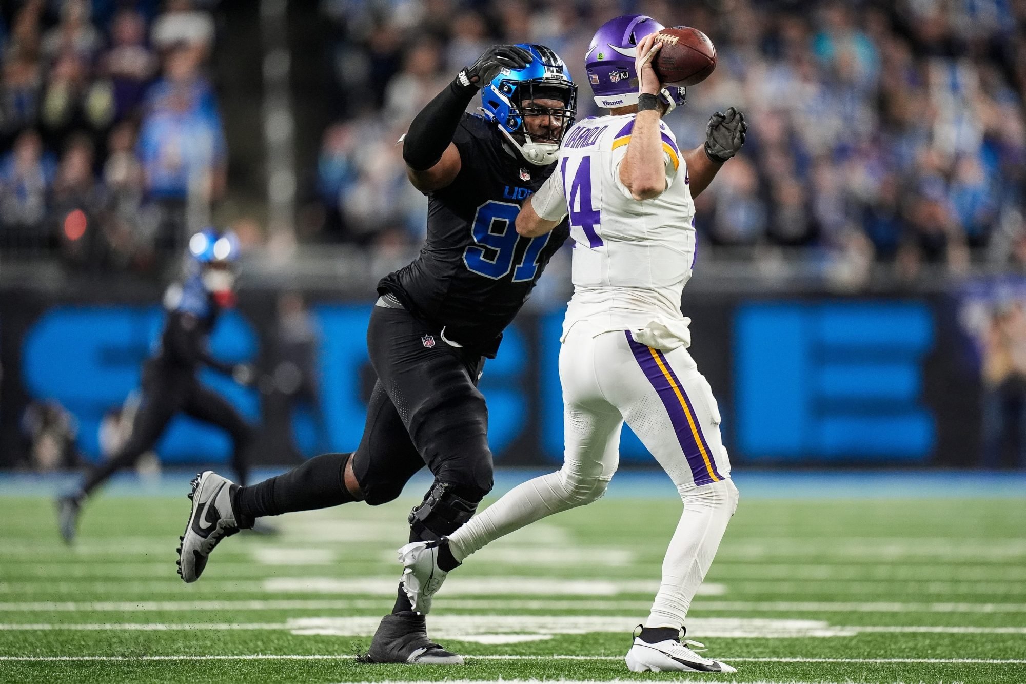 Detroit Lions defensive end Levi Onwuzurike (91) pressures Minnesota Vikings quarterback Sam Darnold (14) during the second half at Ford Field in Detroit on Sunday, Jan. 5, 2025.