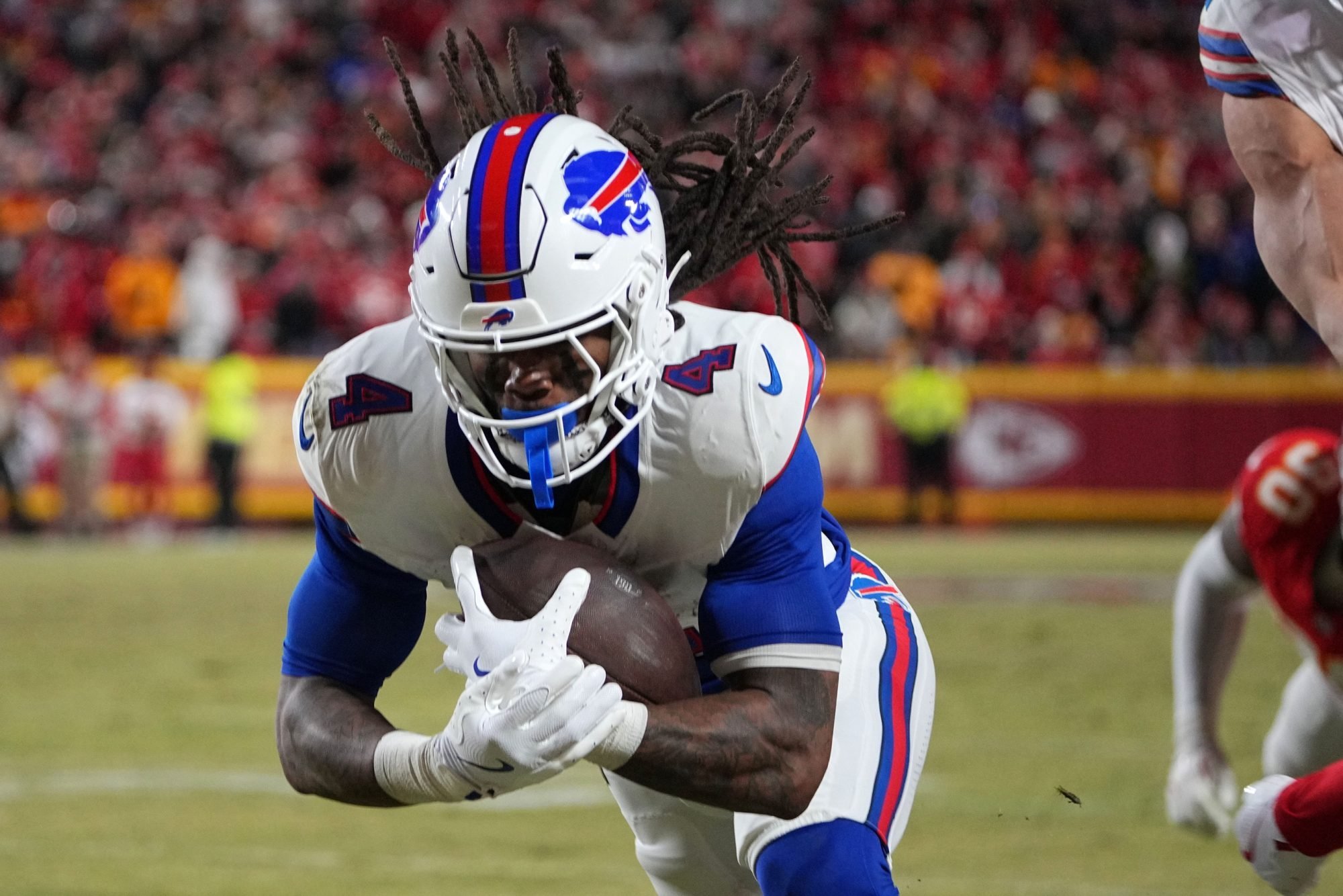 Jan 26, 2025; Kansas City, MO, USA; Buffalo Bills running back James Cook (4) dives for a touchdown against the Kansas City Chiefs in the AFC Championship game at GEHA Field at Arrowhead Stadium.