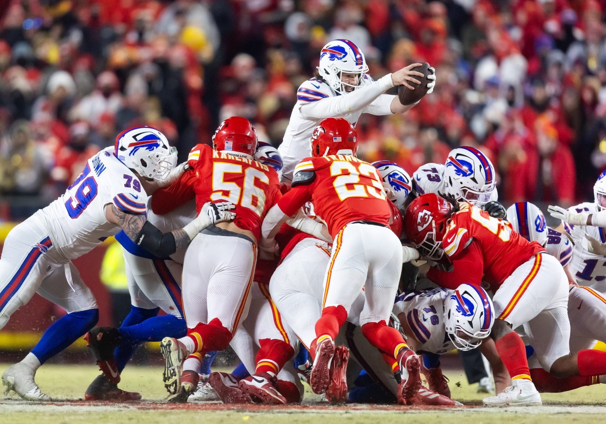 Jan 26, 2025; Kansas City, MO, USA; Buffalo Bills quarterback Josh Allen (17) leaps over the line of Kansas City Chiefs defenders during the AFC Championship game at GEHA Field at Arrowhead Stadium.